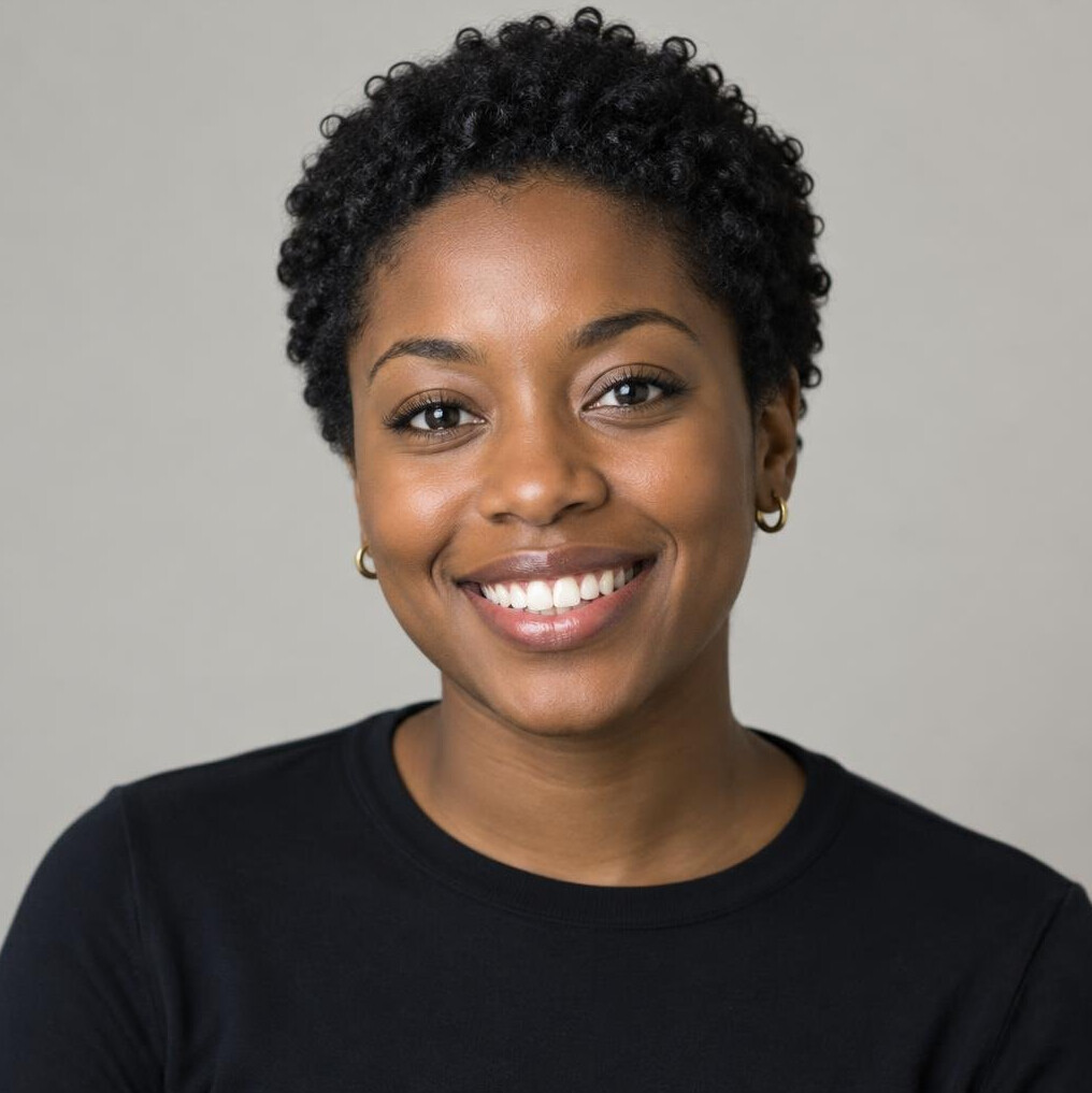 Portrait of a young Black woman with short curly hair smiling